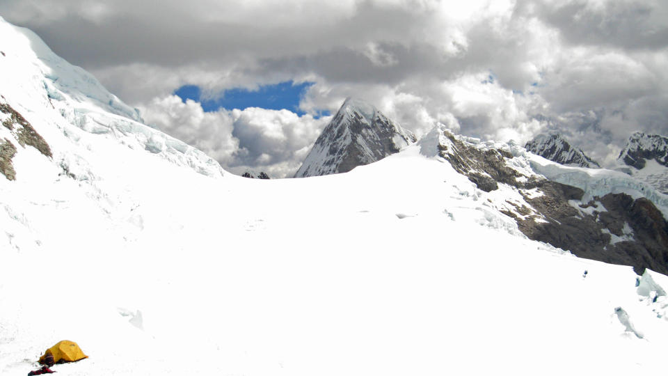 In this Thursday, July 26, 2012 photo released by Peru's police, a yellow tent believed by authorities to belong to U.S. climbers Gil Weiss and Ben Horne, sits near Palcaraju Peak in Huaraz, Peru. A search team reached the climbers' base camp and spotted the apparent tracks of the two 29-year-old U.S. mountaineers who have not been heard from since July 11 when they set off to climb the glacier-capped peak in the Cordillera Blanca range of northern Peru. Weiss and Horne are experienced climbers from Boulder, Colorado. (AP Photo/Peru Police)