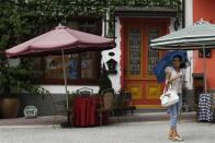 A woman is seen at the replica of Austria's UNESCO heritage site, Hallstatt village, in China's southern city of Huizhou in Guangdong province, June 1, 2012.