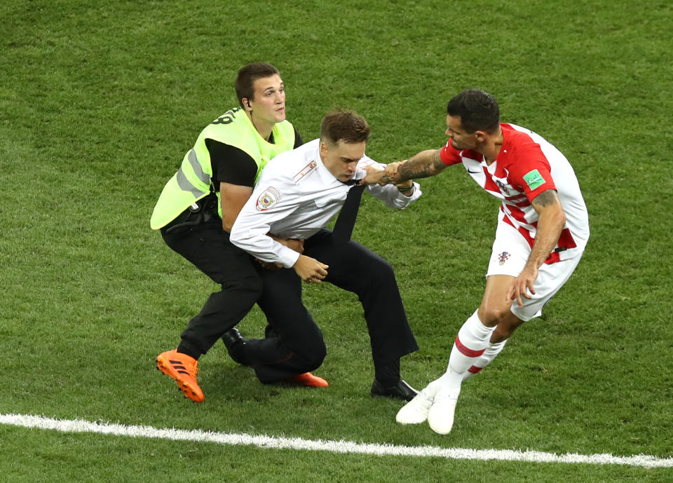 A pitch invader is stopped by Dejan Lovren of Croatia during the 2018 FIFA World Cup Final between France and Croatia at Luzhniki Stadium on July 15, 2018 in Moscow, Russia. (Getty Images)