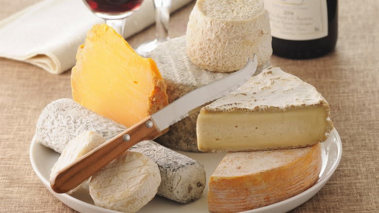 Cheeses on a plate with a knife