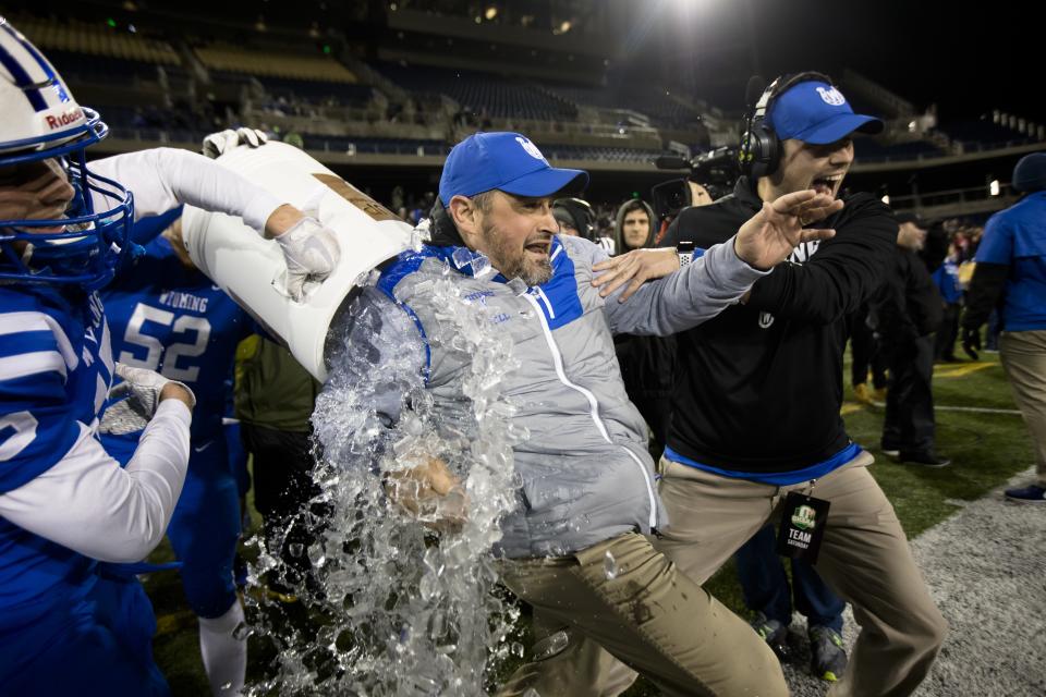 Wyoming's Perry McMichen (15) dunks Wyoming head coach Aaron Hancock as they win the OHSAA Division IV State Championship football game between Wyoming and Girard on Saturday, Dec. 1, 2018, at Tom Benson Stadium in Canton. Wyoming defeated Girard 42-14.