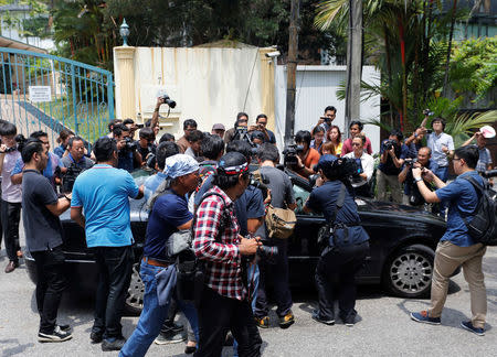 Journalists crowd around a North Korean embassy car leaving the embassy in Kuala Lumpur, Malaysia March 7, 2017. REUTERS/Lai Seng Sin