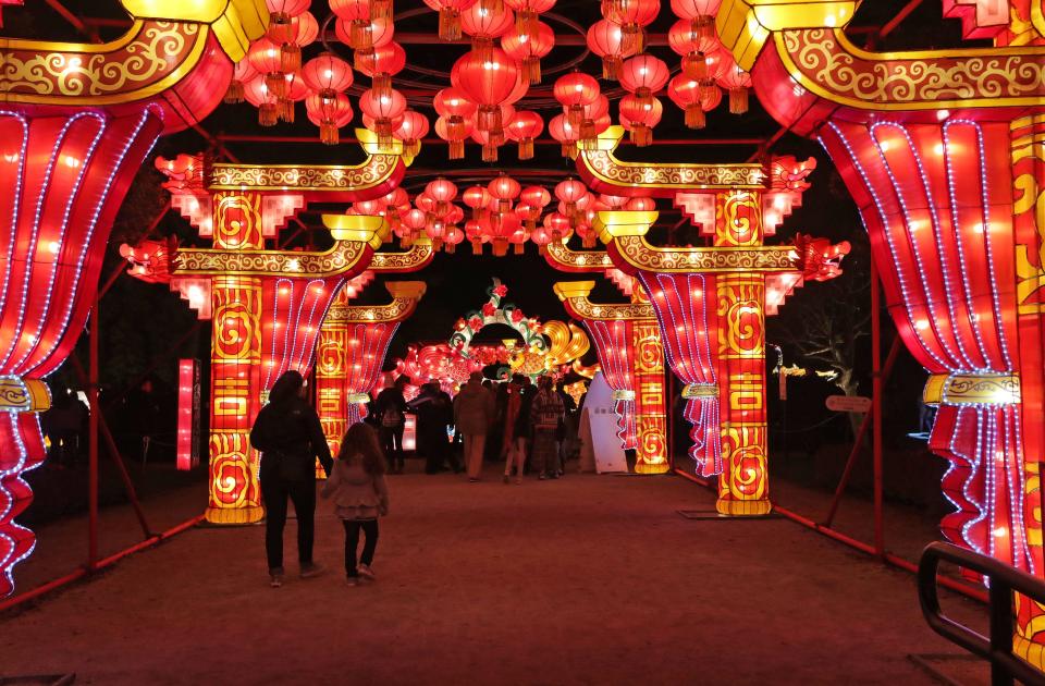 Visitors walk through a tunnel of lights near the entrance of the China Lights lantern festival at Boerner Botanical Gardens in Hales Corners in 2019. This year, after a two-year hiatus due to COVID-19 and staffing shortages, China Lights will return to the gardens Sept. 16-Oct. 30.