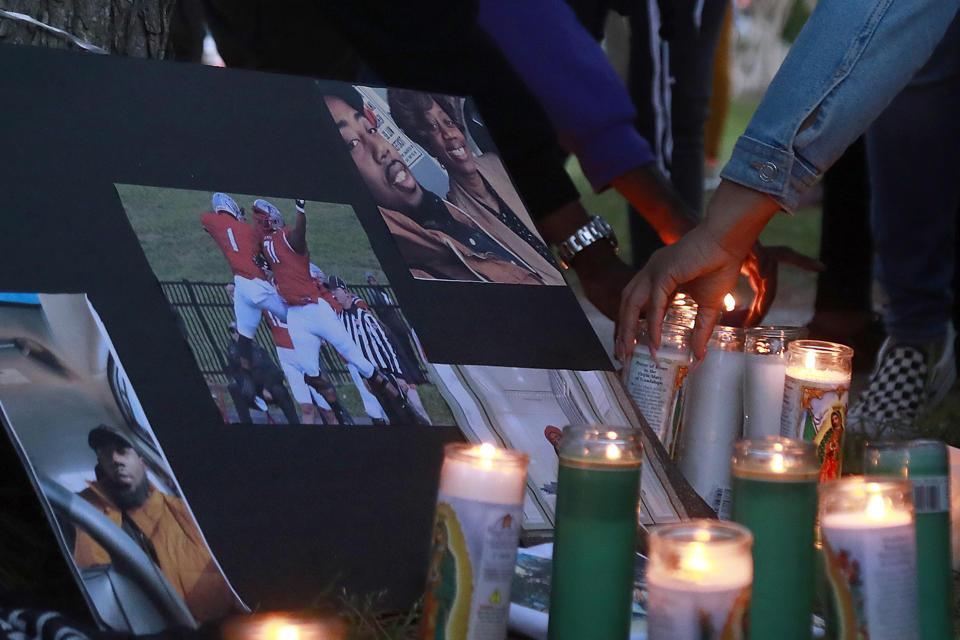 FILE - A person places a candle near a memorial for Donovon Lynch during a vigil on Tuesday, March 30, 2021, in Virginia Beach, Va. The city of Virginia Beach will pay $3 million to settle a lawsuit from the family of Donovon Lynch, a Black man who was shot by police during a chaotic night of violence on the city’s oceanfront last year. (Kaitlin McKeown/The Virginian-Pilot via AP, File)