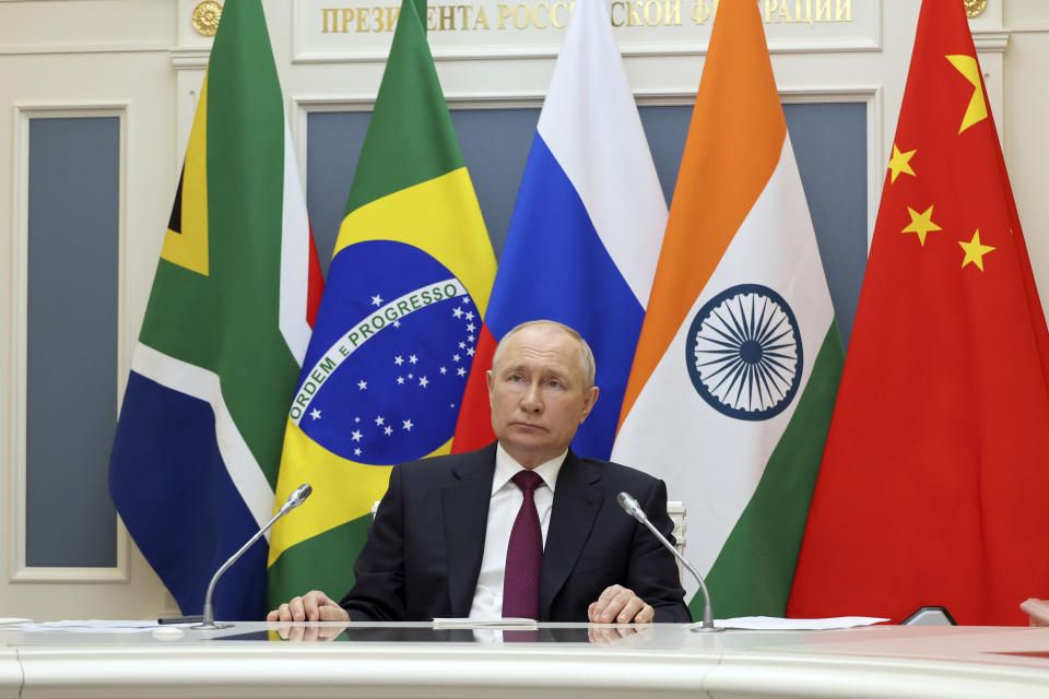 Russian President Vladimir Putin listens to leaders from the BRICS group of emerging economies at the start of a three-day summit in Johannesburg, South Africa via videoconference from Moscow, Russia, Wednesday, Aug. 23, 2023. Putin appeared on a video link after his travel to South Africa was complicated by an International Criminal Court arrest warrant against him over the war in Ukraine. (Mikhail Klimentyev, Sputnik, Kremlin Pool Photo via AP)