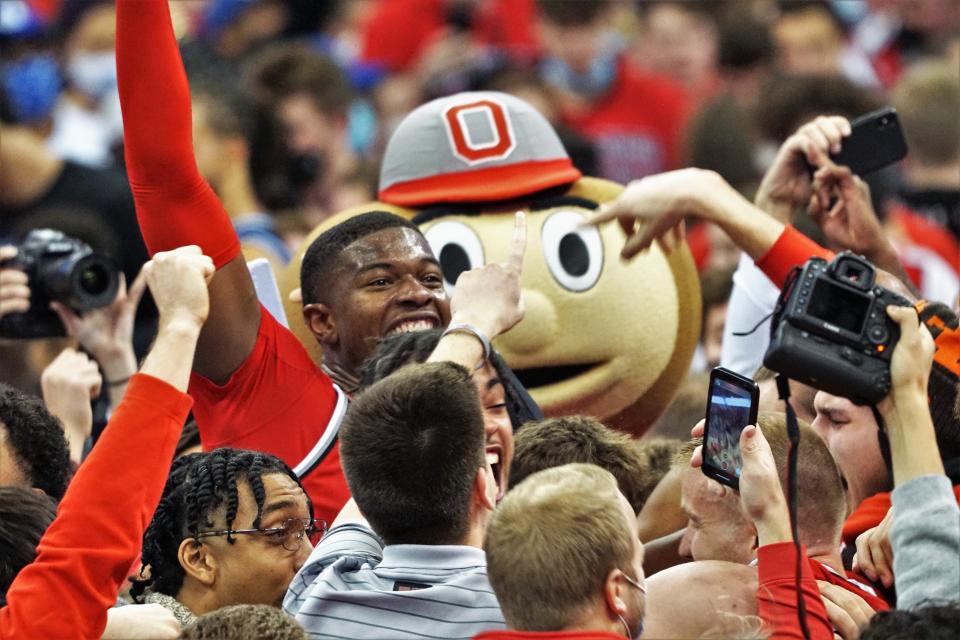 Ohio State's E.J. Liddell celebrates with fans who stormed the court after a 71-66 upset of No. 1 Duke on Nov. 30, 2021