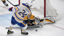 Boston Bruins goaltender Jeremy Swayman drops to the ice to make a save on a shot by Buffalo Sabres center Dylan Cozens (24) during the second period of an NHL hockey game Tuesday, April 13, 2021, in Boston. (AP Photo/Charles Krupa)