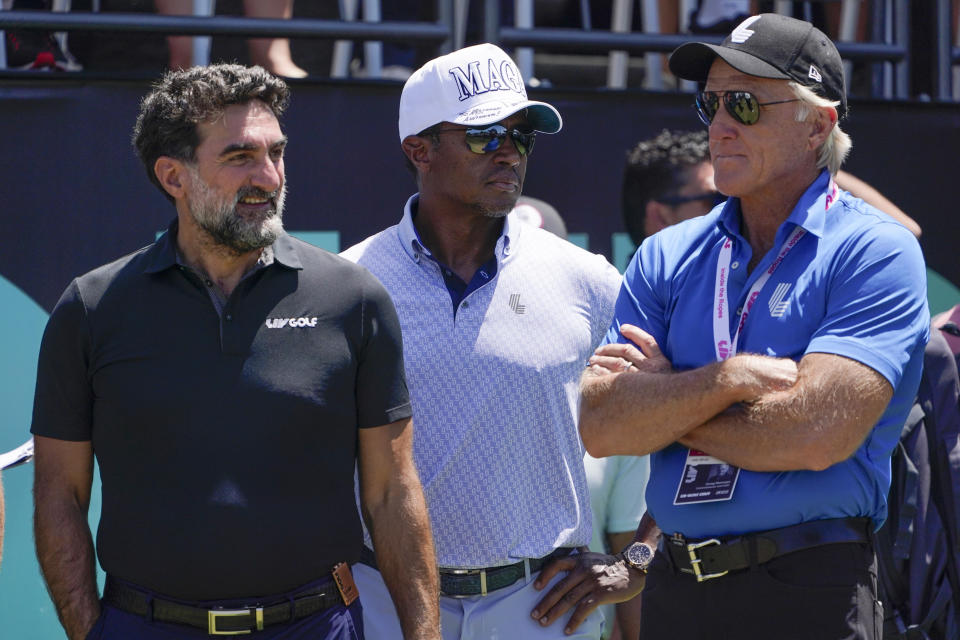 Yasir Al-Rumayyan, governor of Saudi Arabia's Public Investment Fund, left, Majed Al-Sorour, CEO of Golf Saudi, center, and Greg Norman, CEO of LIV Golf, watch at the first tee during the second round of the Bedminster Invitational LIV Golf tournament in Bedminster, N.J., Saturday, July 30, 2022. (AP Photo/Seth Wenig)