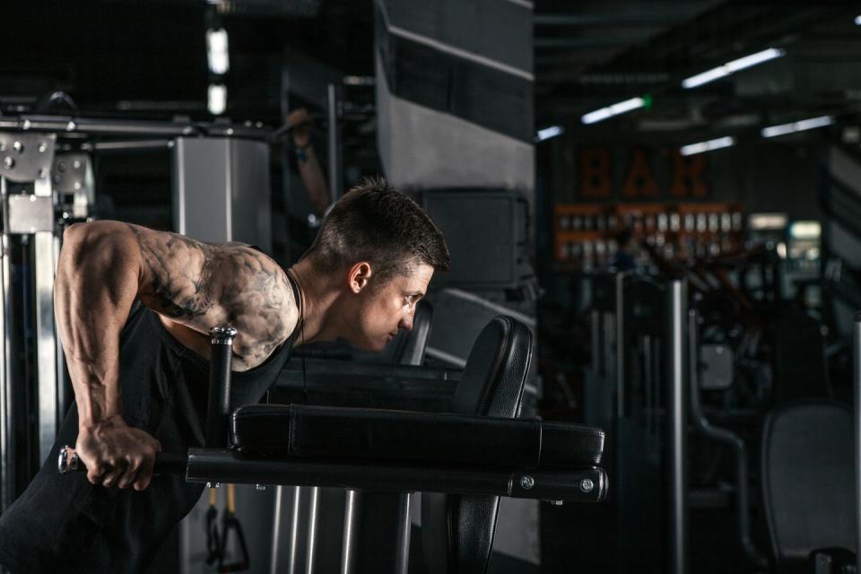 athlete on uneven bars doing triceps exercises