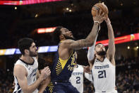 Indiana Pacers forward Oshae Brissett (12) shoots between Memphis Grizzlies forward Santi Aldama (7) and guard Tyus Jones (21) in the second half of an NBA basketball game, Sunday, Jan. 29, 2023, in Memphis, Tenn. (AP Photo/Brandon Dill)