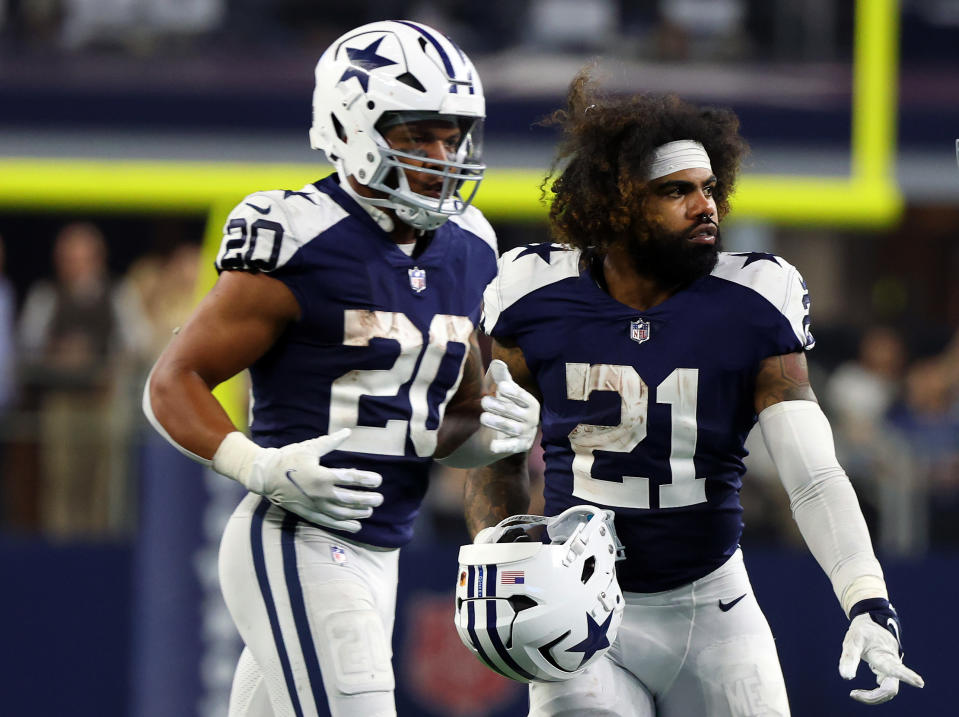 ARLINGTON, TEXAS - NOVEMBER 24: Tony Pollard #20 and Ezekiel Elliott #21 of the Dallas Cowboys stand on the field during the game against the New York Giants at AT&T Stadium on November 24, 2022 in Arlington, Texas. (Photo by Richard Rodriguez/Getty Images)