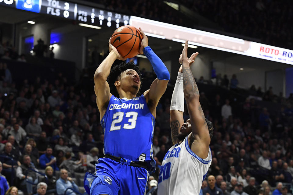 Creighton guard Trey Alexander (23) shoots over Xavier guard Dayvion McKnight (20) during the second half of an NCAA college basketball game in Cincinnati, Ohio, Saturday, Feb. 10, 2024. (AP Photo/Timothy D. Easley)