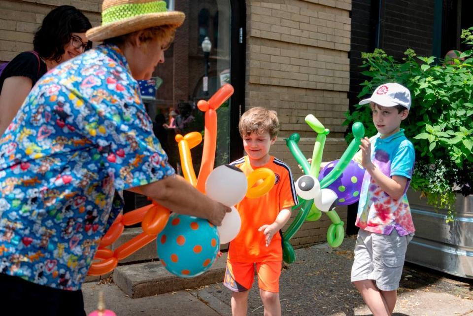 Miss Tillie the Balloonatic makes balloon animals for youngsters during Children and Youth Day at the Central Pennsylvania Festival of the Arts on Wednesday, July 13, 2022. 