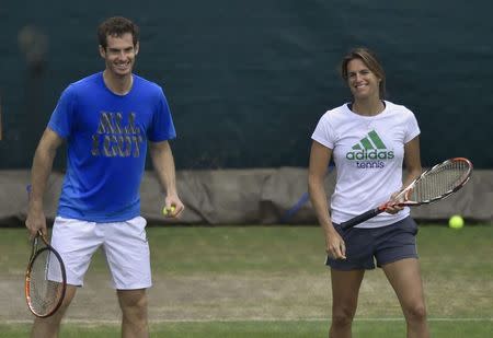 Andy Murray of Britain (L) shares a moment with his coach Amelie Mauresmo as he practices at the Wimbledon Tennis Championships in London June 29, 2014. REUTERS/Toby Melville