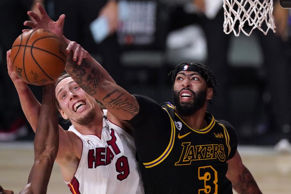 Miami Heat forward Kelly Olynyk (9) and Los Angeles Lakers forward Anthony Davis (3) compete for control of a rebound during the second half of Game 2 of basketball's NBA Finals, Friday, Oct. 2, 2020, in Lake Buena Vista, Fla. (AP Photo/Mark J. Terrill)