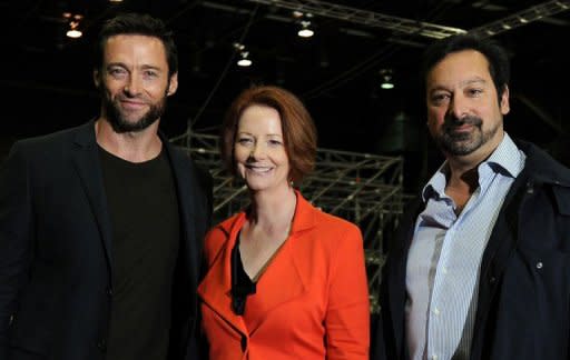 Actor Hugh Jackman (L), Australian Prime Minister Julia Gillard (C), and US director James Mangold at the set of the movie 'The Wolverine' in July. Gillard said it was Jackman himself who convinced her to provide the money to bring the film's production to Australia because it would create more than 2,000 jobs and keep specialist skills in the country