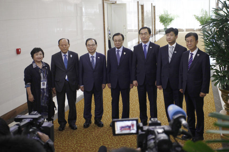 South Korean Unification Minister Cho Myoung-gyon, third right, and delegation members pose for the media on their arrival at the Pyongyang Airport in Pyongyang, North Korea Thursday, Oct. 4, 2018. The delegation flew to North Korea on Thursday for a joint celebration of the anniversary of a 2007 summit and to possibly hold further peace talks. (AP Photo/Jon Chol Jin)