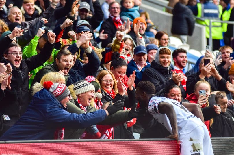 Emmanuel Latte Lath celebrates with Boro fans after scoring boro's third goal against Cardiff