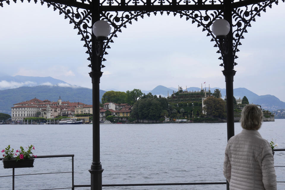 A woman looks at the Isola Bella (Bella Island), on Lake Maggiore where Louis Vuitton presented the women's Cruise 2024 collection, in Stresa, northern Italy, Wednesday, May 24, 2023. (AP Photo/Antonio Calanni)