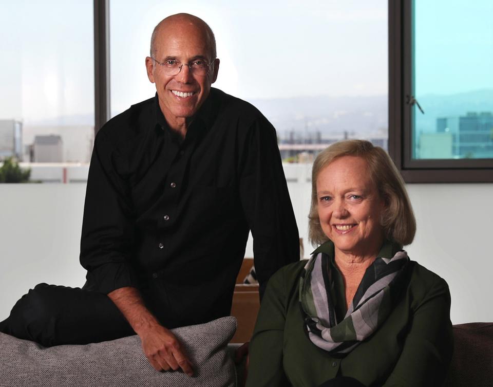 Jeffrey Katzenberg, left, and Meg Whitman pose in front of windows