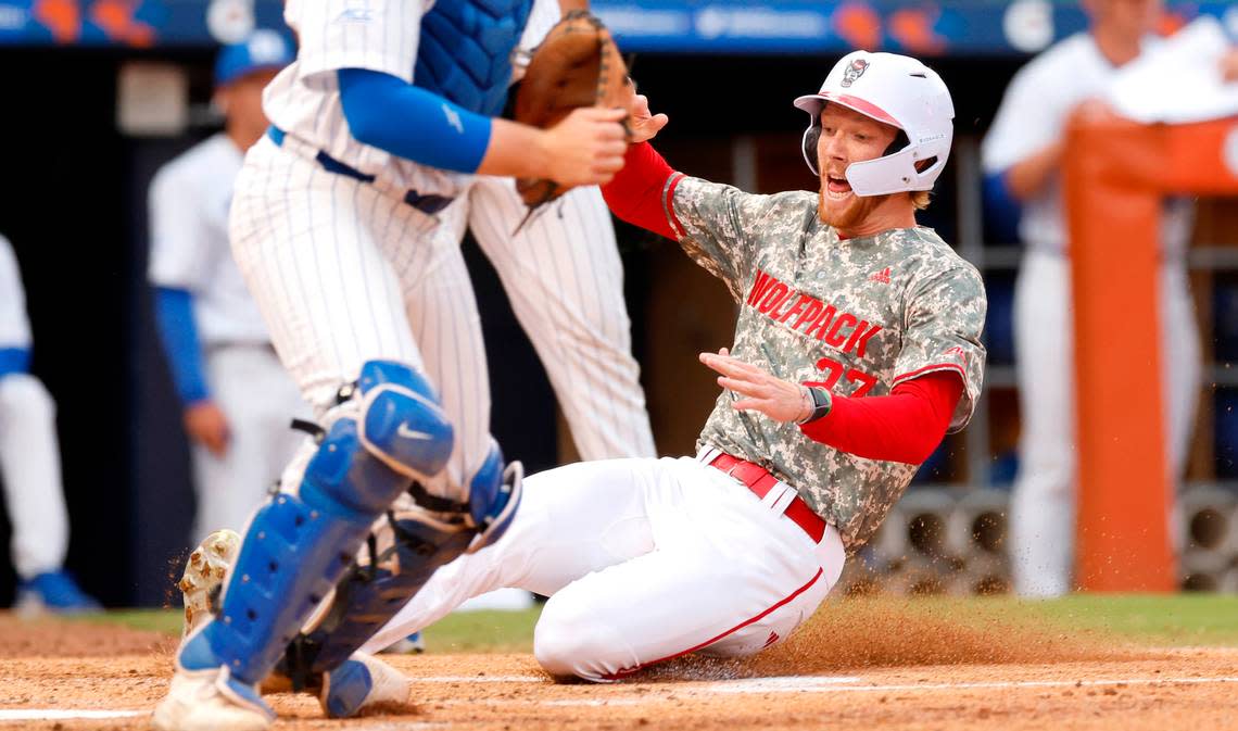 N.C. State’s Parker Nolan (27) slides into home scoring on a double by Kalae Harrison in the second inning during Duke’s game against N.C. State in the ACC Baseball Championship at the Durham Bulls Athletic Park in Durham, N.C., Tuesday, May 23, 2023.