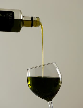 Olive oil is decanted in a glass at an oil cooperative in Porcuna, southern Spain