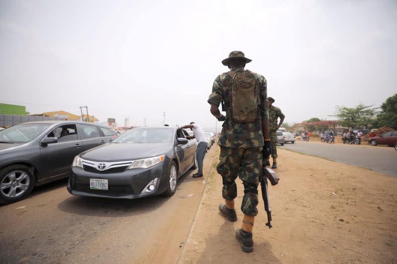 FILE PHOTO: A soldier observes temperature checks at the border between Abuja and Nasarawa as the authorities try to limit the spread of the coronavirus in Nigeria