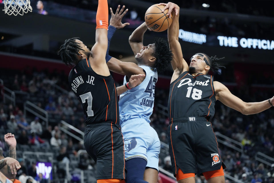 Detroit Pistons forward Tosan Evbuomwan (18) blocks a shot by Memphis Grizzlies forward GG Jackson (45) during the first half of an NBA basketball game, Monday, April 1, 2024, in Detroit. (AP Photo/Carlos Osorio)