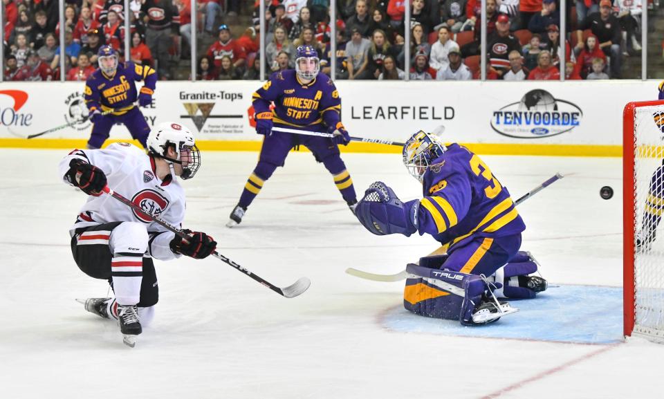 St. Cloud State's Grant Cruikshank gets the puck past Alex Tracy of MSU-Mankato for the Huskie's first goal during the first period of the game Saturday, Oct. 22, 2022, at the Herb Brooks National Hockey Center in St. Cloud.  