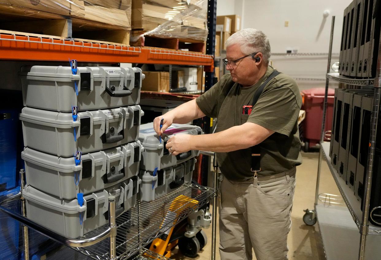 Williamson County elections operations clerk David Kohn secures equipment at the elections office in Georgetown on Thursday.