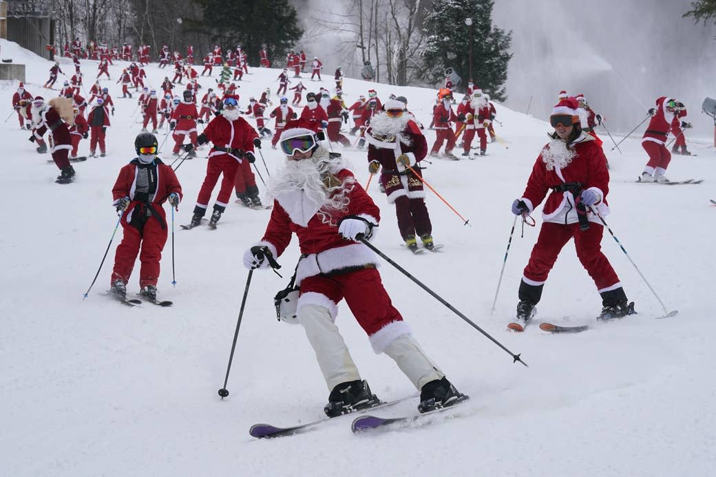 Skiers dressed in Santa Claus outfits hit the slopes for charity at the Sunday River ski resort in Newry, Maine, on Dec. 11, 2022.