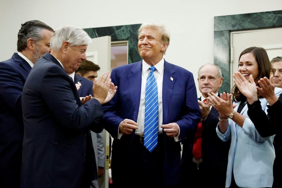 Trump is applauded by Senate Republicans in Washington DC on Thursday (Getty)