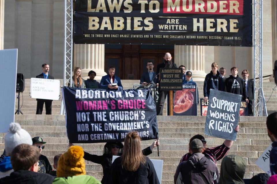 Anti-abortion protestors and abortion rights counter-protestors face off at the Statehouse last month.