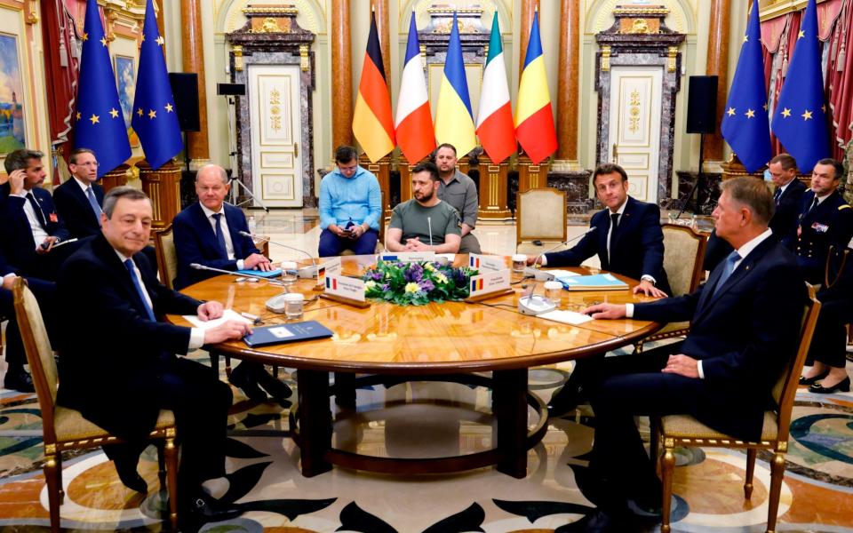 Italian Prime Minister Mario Draghi, left, German Chancellor Olaf Scholz, second left, Ukrainian President Volodymyr Zelensky, center, French President Emmanuel Macron second right, and Romanian President Klaus Iohannis meet for a working session in Mariinsky Palace, in Kyiv - Ludovic Marin 