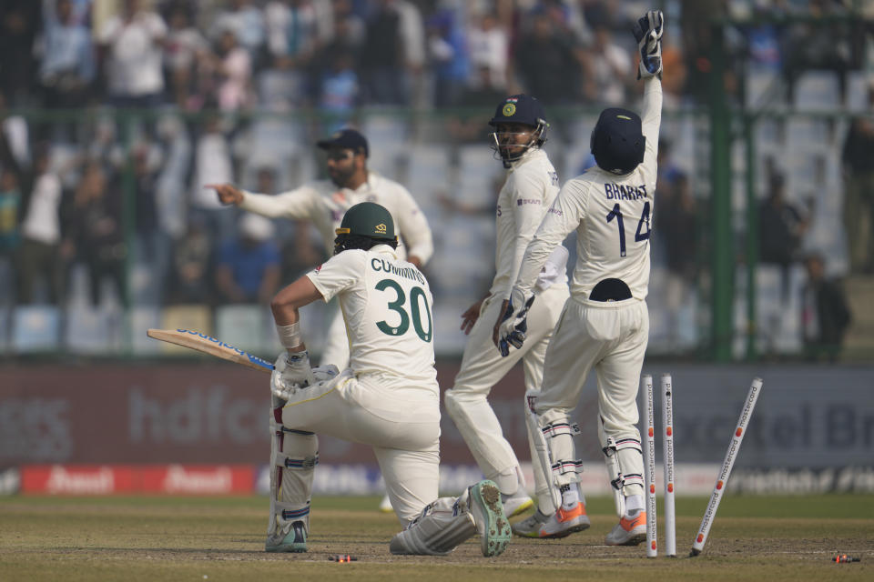 Indian players celebrate dismissal of Australia's Pat Cummins, left, during the third day of the second cricket test match between India and Australia in New Delhi, India, Sunday, Feb. 19, 2023. (AP Photo/Altaf Qadri)