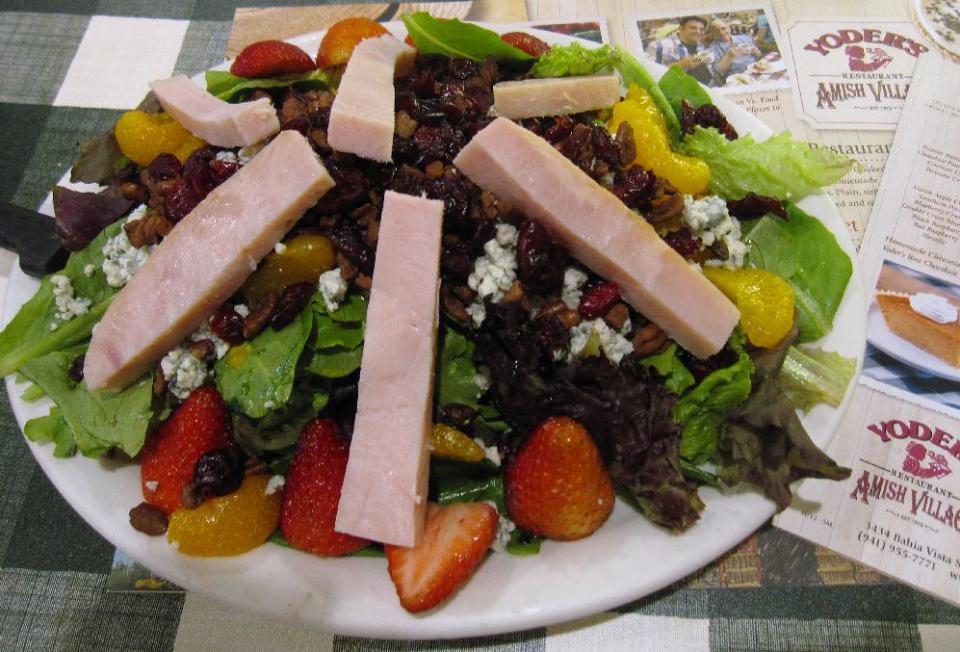 This Oct. 12, 2013 photo shows a dish called Anna’s salad at Yoder’s Restaurant in Sarasota, Fla. The restaurant is known for “homestyle Amish food” and is extremely popular with locals and tourists alike, but its menu includes some items that are not typical Amish fare, such as creative salads and quesadillas. (AP Photo/Beth J. Harpaz)