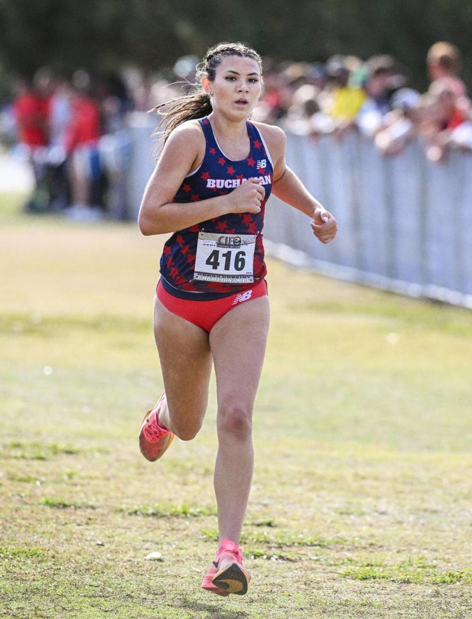 Buchanan’s Elle Lomeli is alone in first place as she crosses the finish line in the Central Section girls Division 1 championship cross country race at Woodward Park on Thursday, Nov. 16, 2023. Lomeli won the race and Buchanan swept the top five finishers capturing the team championship.