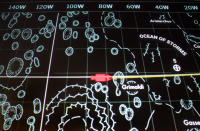 A wall screen shows a lunar map and the simulated position of the Command Module, in red, as it would orbit the moon inside the mission control room being restored to replicate the Apollo mission era 50 years earlier, at the NASA Johnson Space Center Monday, June 17, 2019, in Houston. (AP Photo/Michael Wyke)
