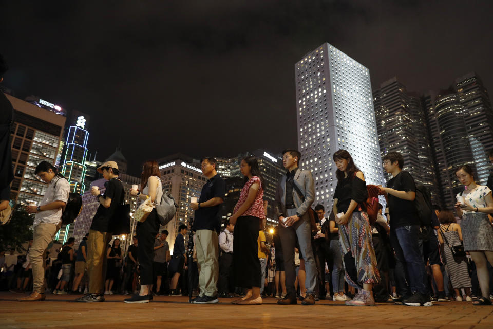 Protesters join a candle light vigil for the fourth apparent suicide related to the protests against an extradition law to China in Hong Kong on Wednesday, July 10, 2019. It's still the world's "freest" economy, one of the biggest global financial centers and a scenic haven for tycoons and tourists, but the waves of protests rocking Hong Kong are exposing strains unlikely to dissipate as communist-ruled Beijing's influence grows.(AP Photo/Vincent Yu)