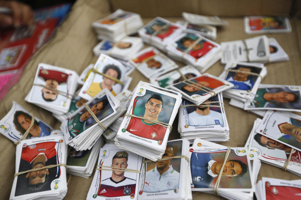 Stickers from the official 2014 FIFA World Cup sticker album are grouped to be exchanged between collectors along a street in Lima, May 1, 2014. The official 2014 FIFA World Cup sticker album is sold in 120 countries across the world, according to the publisher Panini. REUTERS/Mariana Bazo (PERU - Tags: SPORT SOCCER WORLD CUP SOCIETY)