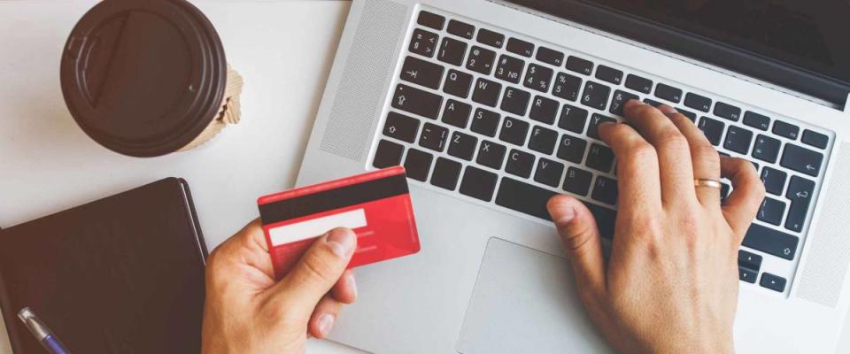 Top view of man using credit card for online shoping