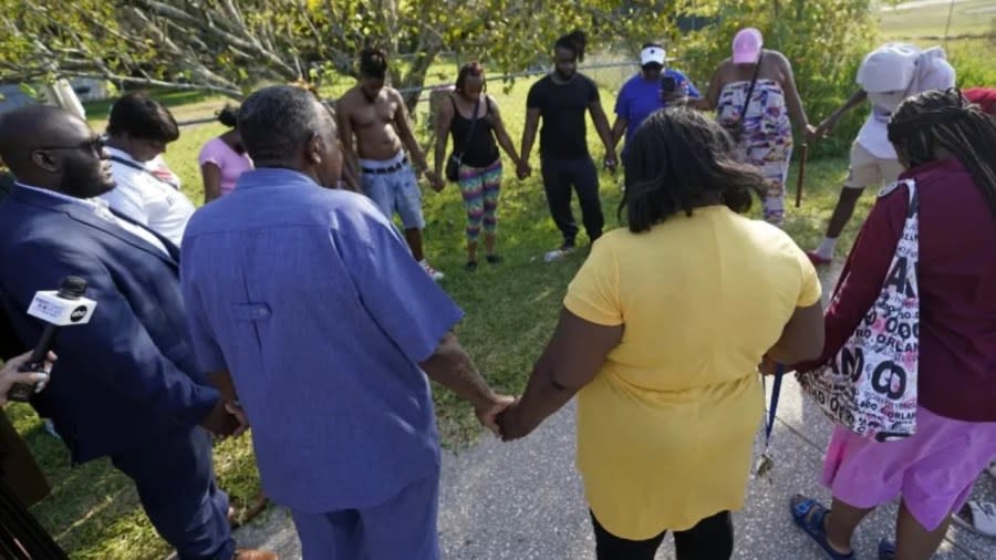 Area residents gather for a prayer near the scene of a mass shooting at a Dollar General store Saturday in Jacksonville, Florida. (Photo by John Raoux/AP)