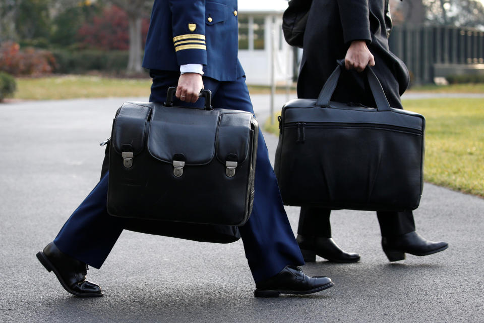 A military aide carries the so-called “nuclear football” (Reuters)