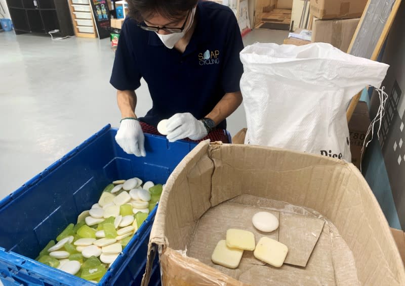 A staff member of Soap Cycling, a Hong Kong-based non-governmental organisation, sorts used soap collected from hotels before reprocessing them at their warehouse, in Hong Kong