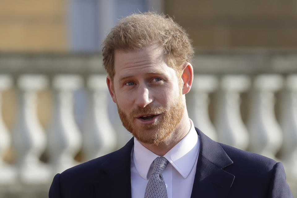 Britain's Prince Harry gestures in the gardens of Buckingham Palace in London, Thursday, Jan. 16, 2020. Prince Harry, the Duke of Sussex will host the Rugby League World Cup 2021 draw at Buckingham Palace, prior to the draw, The Duke met with representatives from all 21 nations taking part in the tournament, as well as watching children from a local school play rugby league in the Buckingham Palace gardens. (AP Photo/Kirsty Wigglesworth)