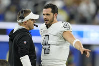 Las Vegas Raiders head coach Josh McDaniels, left, talks with quarterback Derek Carr during the second half of an NFL football game against the Los Angeles Rams, Thursday, Dec. 8, 2022, in Inglewood, Calif. (AP Photo/Marcio Jose Sanchez)