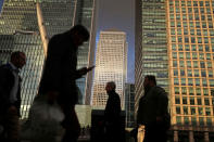 FILE PHOTO: People walk through the Canary Wharf financial district of London, Britain, December 7, 2018. REUTERS/Simon Dawson/File Photo