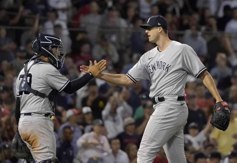 New York Yankees relief pitcher Clay Holmes is congratulated by catcher Jose Trevino (39) after the team's win over the Boston Red Sox in a baseball game at Fenway Park, Thursday, July 7, 2022, in Boston. (AP Photo/Mary Schwalm)