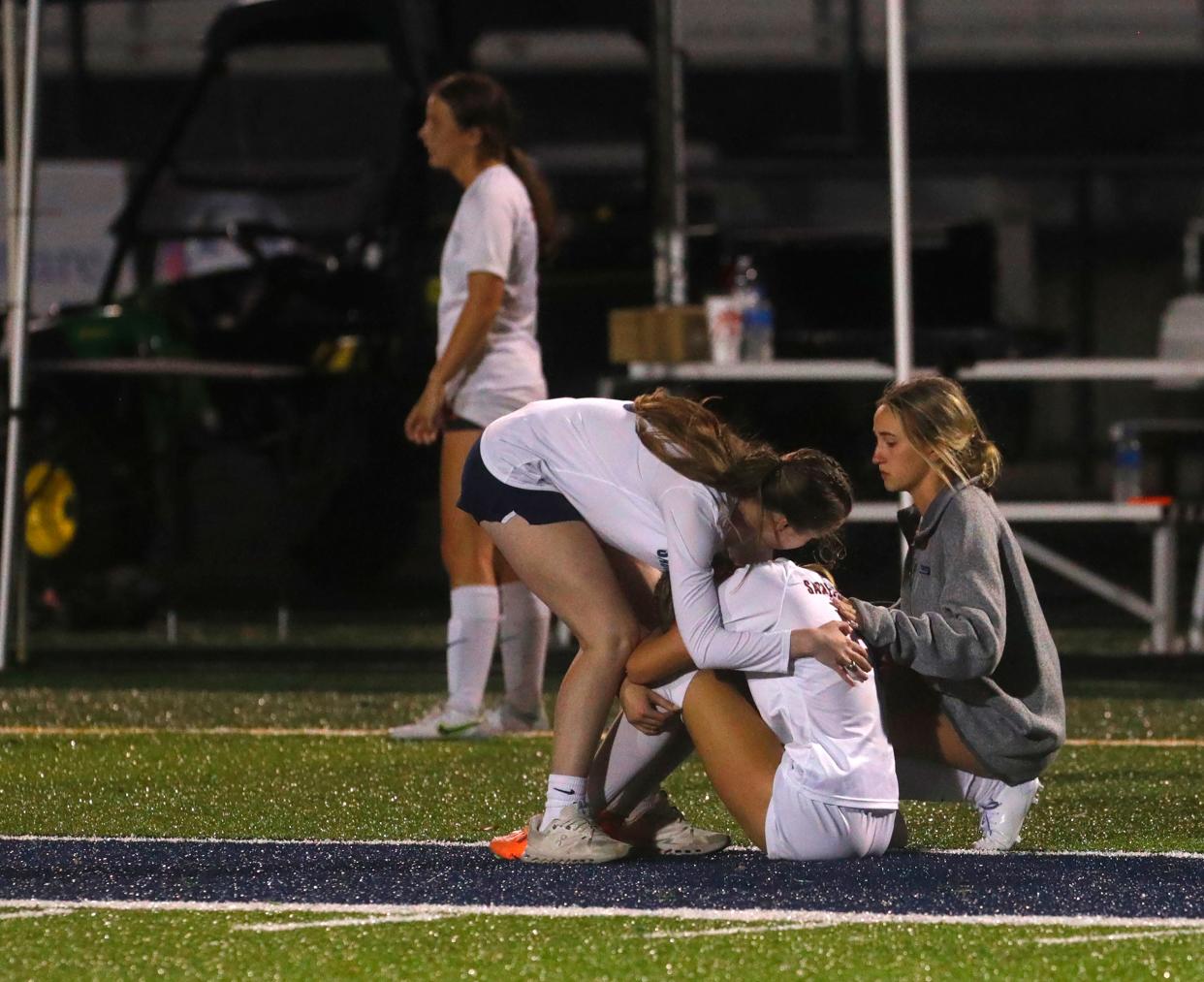 Sacred Heart’s Ava Hendrick was comforted by teammates after the Valkyries lost in the state championship against Bethlehem on Saturday night.