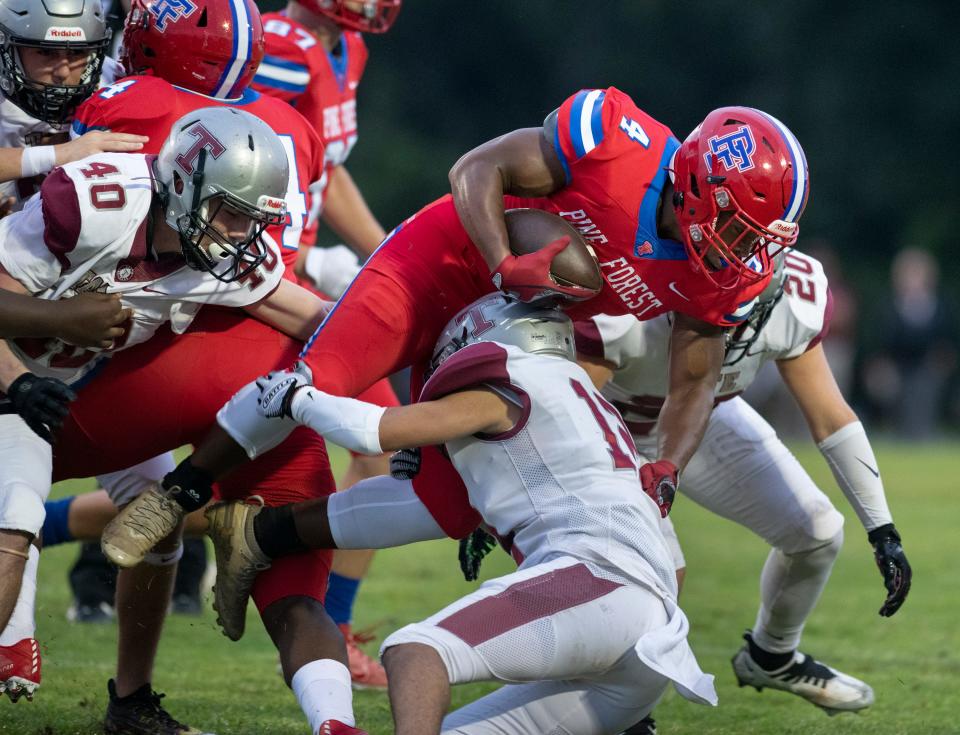Kobe Johnson (4) carries the ball during the Tate vs Pine Forest football game at Pine Forest High School in Pensacola on Thursday, Aug. 25, 2022.